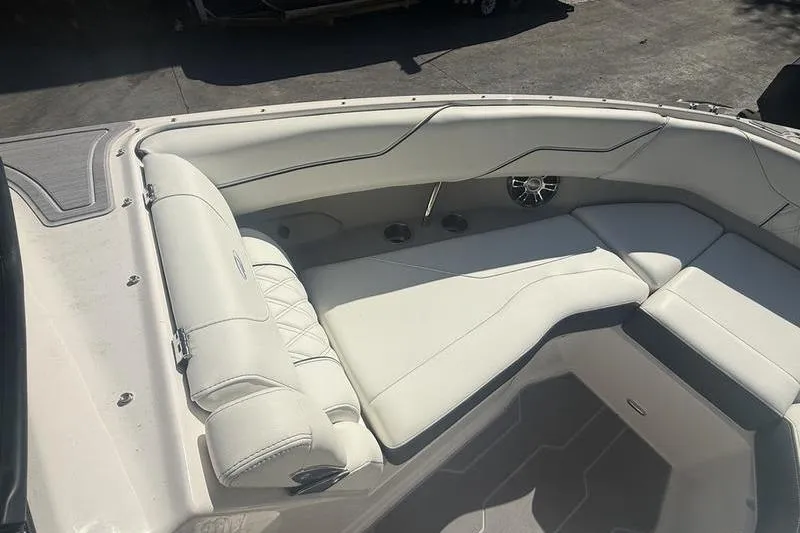 Slide: The Image of 2023 Regal LS4 Surf boat interior with white cushioned seating. - 14
