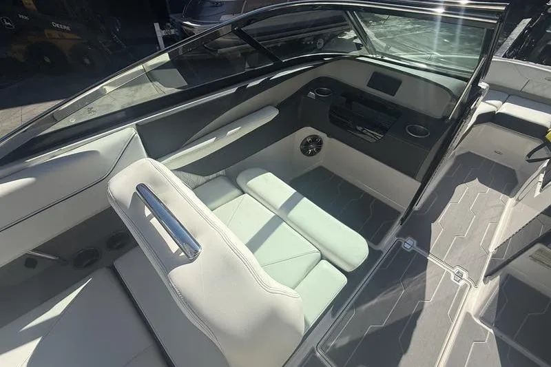 Slide: The Image of 2023 Regal LS4 Surf boat interior with sleek seating and modern dashboard design. - 16