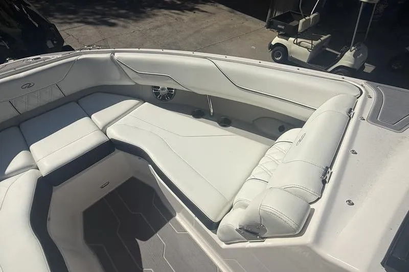 Slide: The Image of 2023 Regal LS4 Surf boat interior with white seating and speaker system. - 18