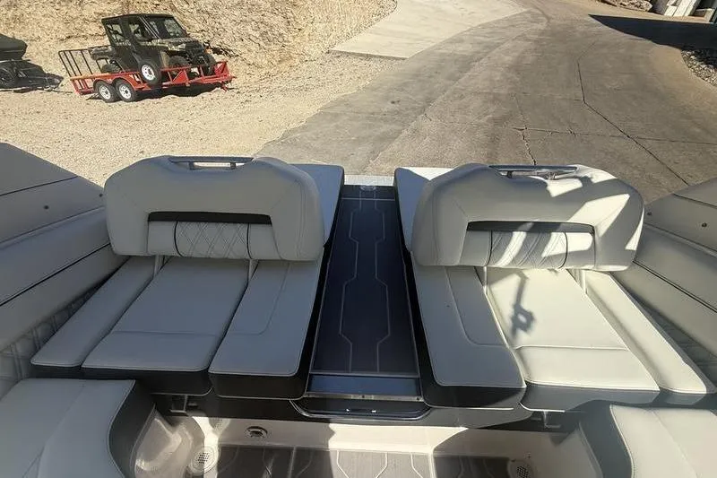 Slide: The Image of 2023 Regal LS4 Surf boat interior with luxurious seating and sleek design. - 8