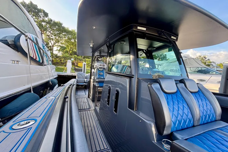 Slide: The Image of 2016 Hydra-Sports 4200 Siesta boat with sleek design and blue seating, docked outdoors. - 10