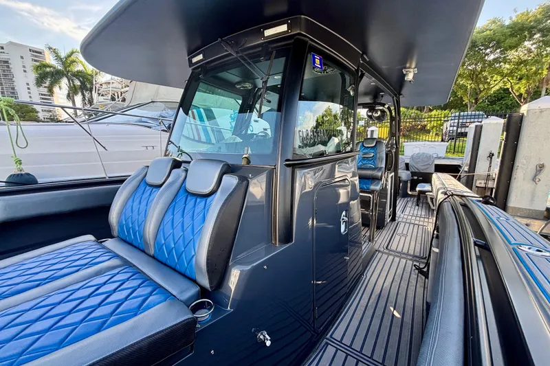Slide: The Image of 2016 Hydra-Sports 4200 Siesta boat interior with blue seating and modern design. - 11