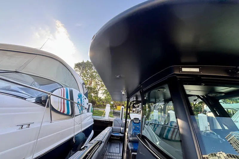 Slide: The Image of 2016 Hydra-Sports 4200 Siesta docked beside another boat, showcasing sleek design. - 13