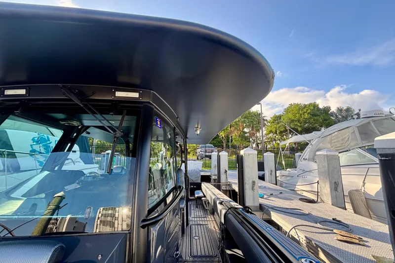 Slide: The Image of 2016 Hydra-Sports 4200 Siesta boat docked, showcasing sleek design and modern features. - 14