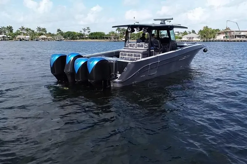 Slide: The Image of 2016 Hydra-Sports 4200 Siesta boat with four engines on calm water. - 2