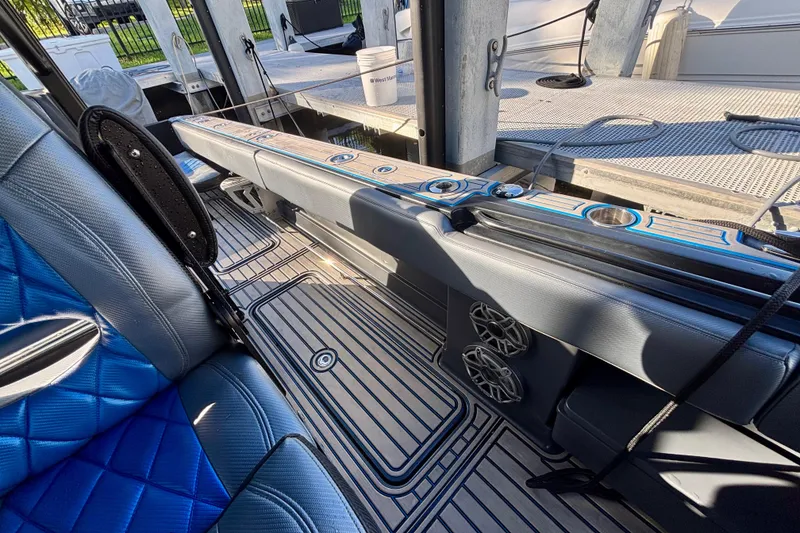 Slide: The Image of 2016 Hydra-Sports 4200 Siesta boat interior with blue seating and cup holders. - 44