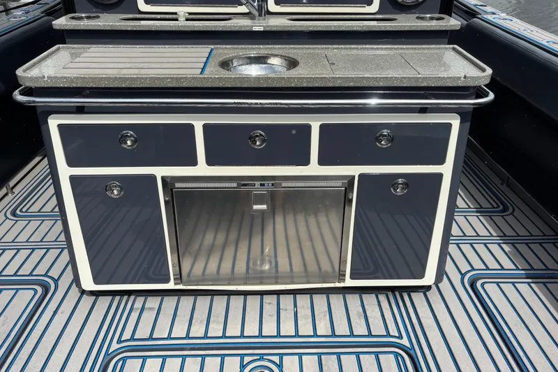Slide: The Image of 2016 Hydra-Sports 4200 Siesta boat kitchen with sleek countertop and storage cabinets. - 47