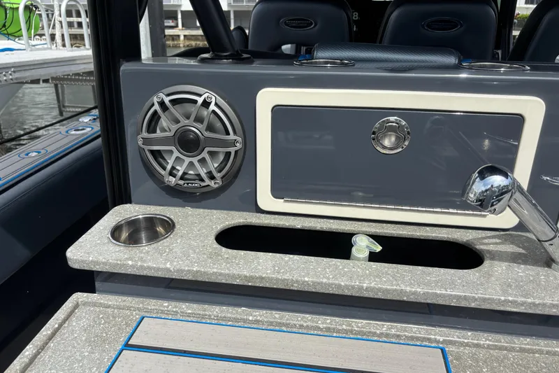 Slide: The Image of 2016 Hydra-Sports 4200 Siesta boat interior with speaker, faucet, and storage compartment. - 49