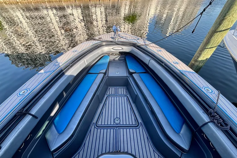 Slide: The Image of 2016 Hydra-Sports 4200 Siesta boat interior with blue seating, docked on calm water. - 5