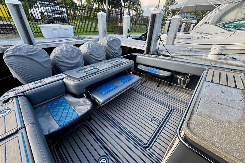 Slide: The Image of 2016 Hydra-Sports 4200 Siesta boat interior with cushioned seating and covered engines. - 54
