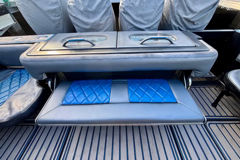 Slide: The Image of 2016 Hydra-Sports 4200 Siesta boat seating with blue quilted cushions and storage compartment. - 58