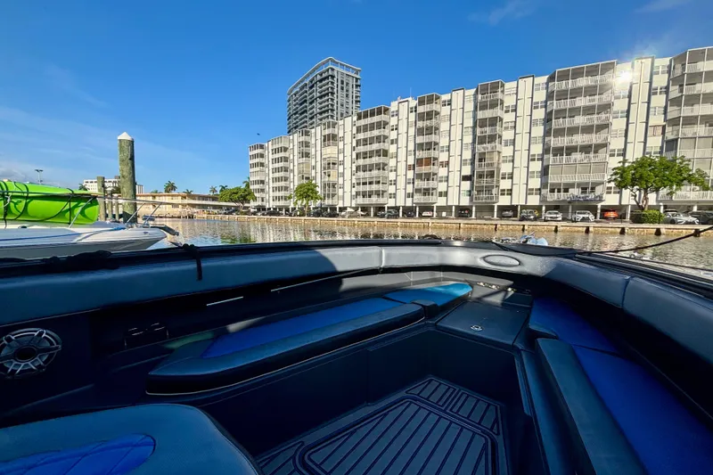Slide: The Image of 2016 Hydra-Sports 4200 Siesta boat docked near waterfront buildings under clear blue sky. - 6