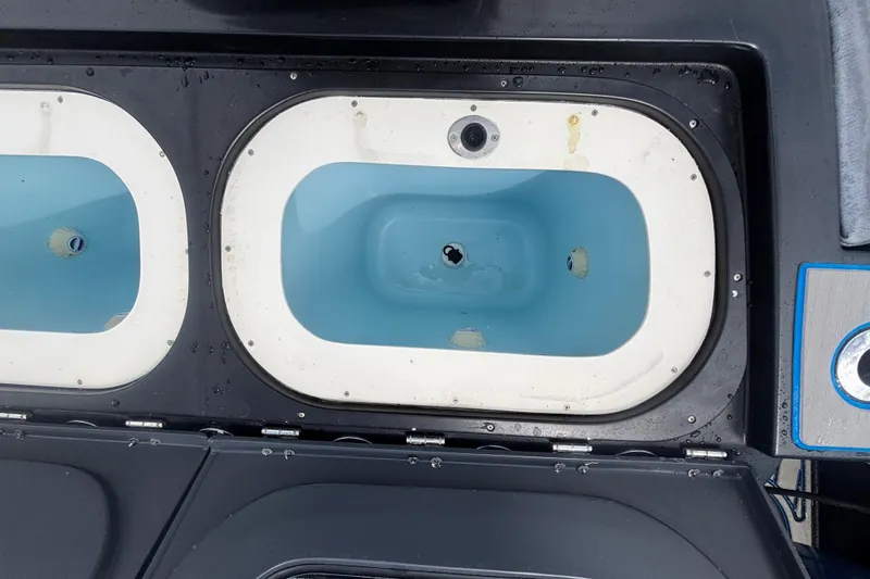 Slide: The Image of Livewell compartments on a 2016 Hydra-Sports 4200 Siesta boat, featuring blue interiors. - 62