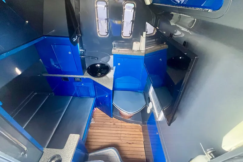 Slide: The Image of 2016 Hydra-Sports 4200 Siesta interior with blue cabinetry and wooden flooring. - 64