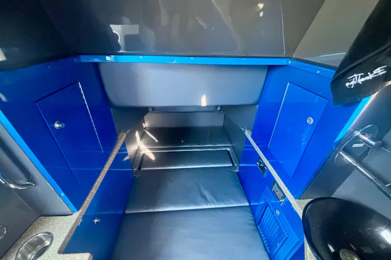 Slide: The Image of 2016 Hydra-Sports 4200 Siesta interior cabin with blue accents and seating. - 65