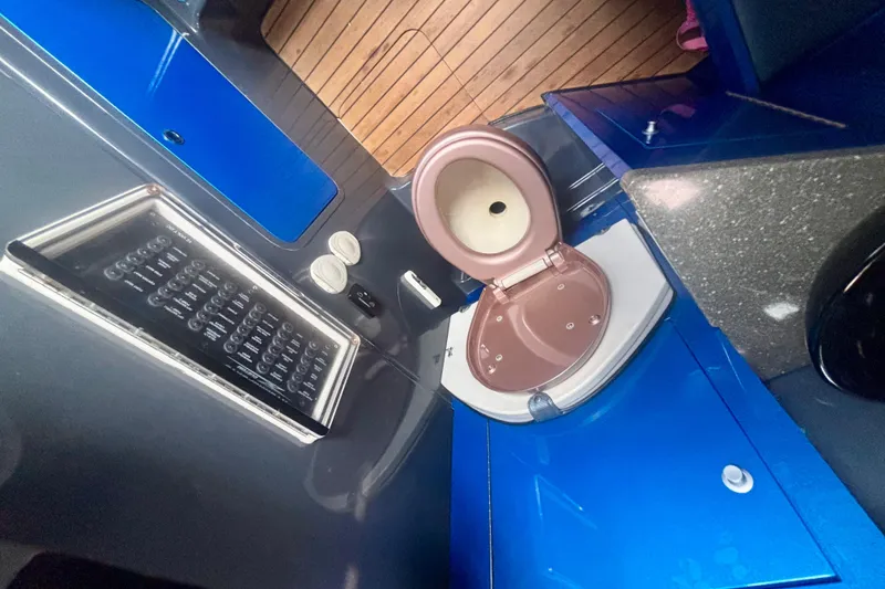 Slide: The Image of 2016 Hydra-Sports 4200 Siesta boat bathroom with modern fixtures and wooden accents. - 66