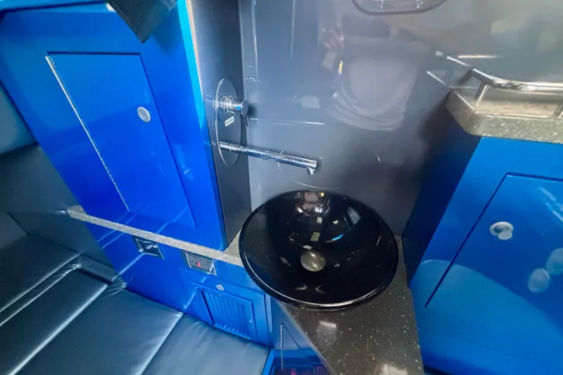 Slide: The Image of Interior of 2016 Hydra-Sports 4200 Siesta with sleek blue cabinetry and modern sink. - 67