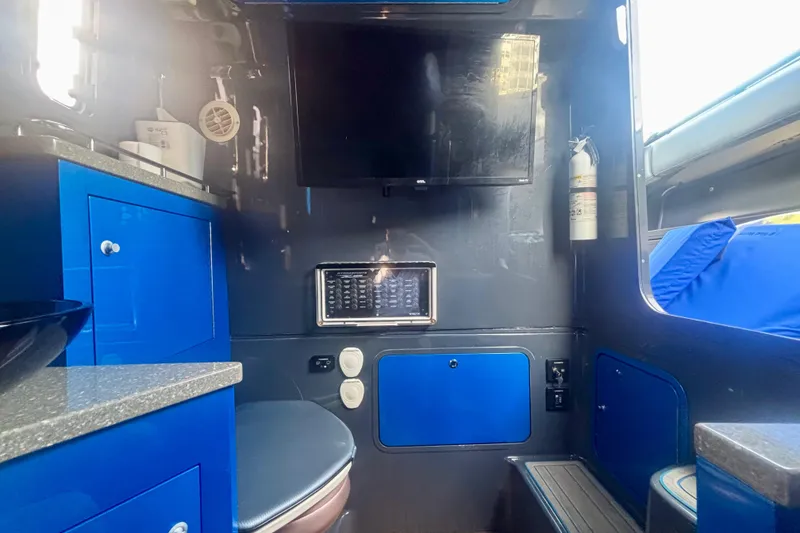 Slide: The Image of Interior of 2016 Hydra-Sports 4200 Siesta boat with blue cabinetry and modern amenities. - 68