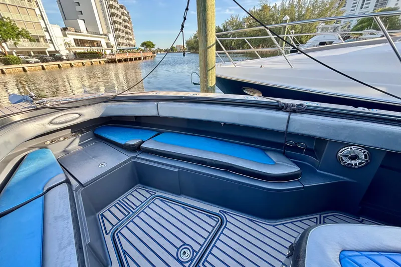 Slide: The Image of 2016 Hydra-Sports 4200 Siesta boat interior with blue seating, docked near waterfront buildings. - 7