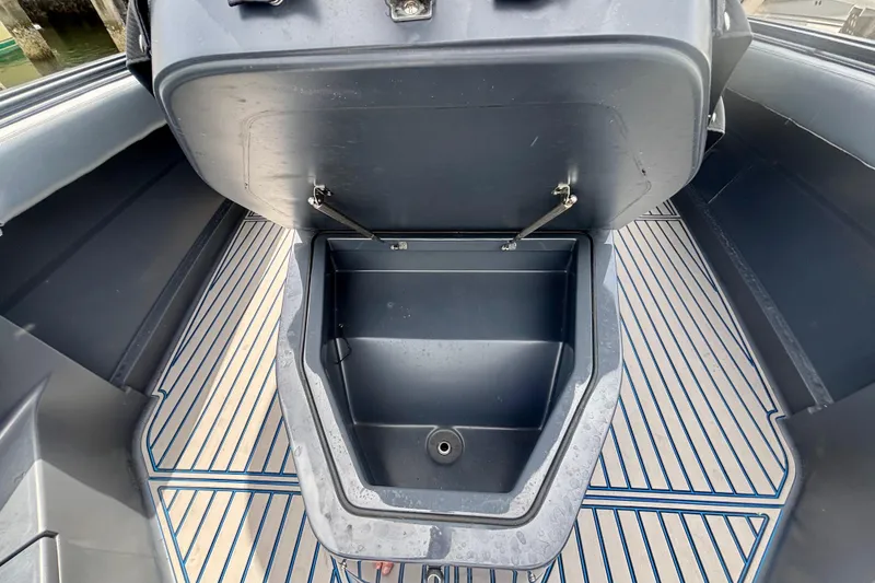 Slide: The Image of 2016 Hydra-Sports 4200 Siesta boat storage compartment with open lid and striped flooring. - 9