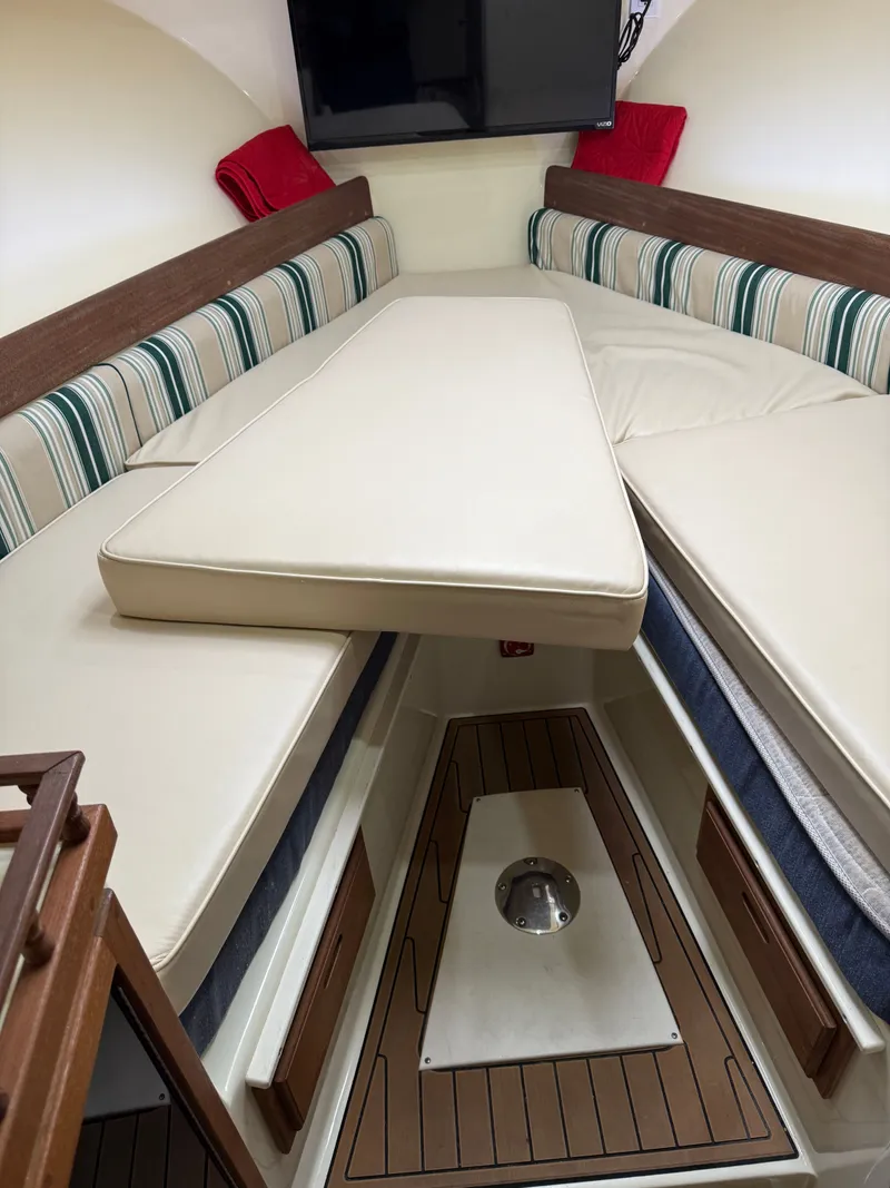 Slide: The Image of Interior of a 2018 Eastern 27 Islander Hardback boat with cushioned seating. - 23