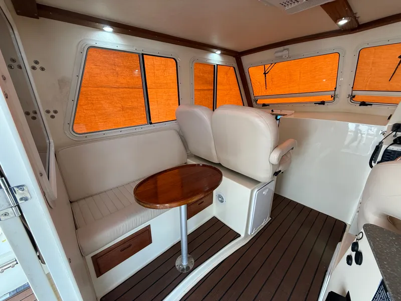 Slide: The Image of Interior of a 2018 Eastern 27 Islander Hardback boat with seating area. - 34