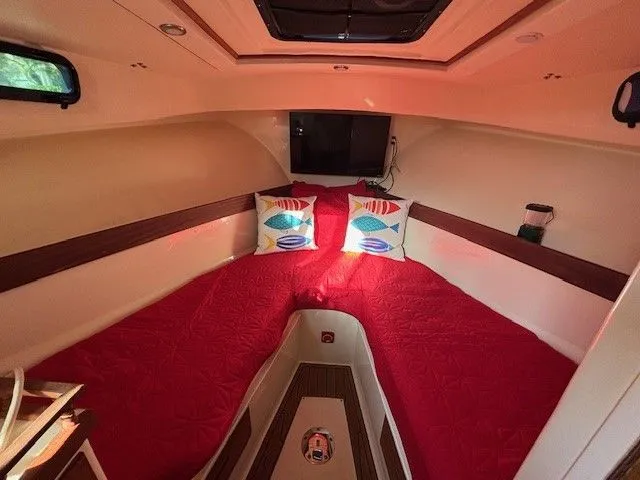 Slide: The Image of Interior of a 2018 Eastern 27 Islander Hardback with red bedding. - 6