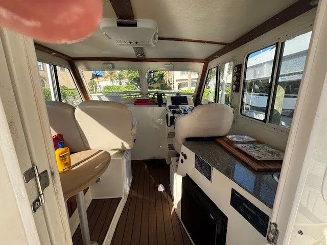 Slide: The Image of Interior of a 2018 Eastern 27 Islander Hardback boat with seating and helm. - 8