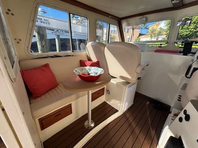 Slide: The Image of Interior of a 2018 Eastern 27 Islander Hardback boat with seating area. - 2