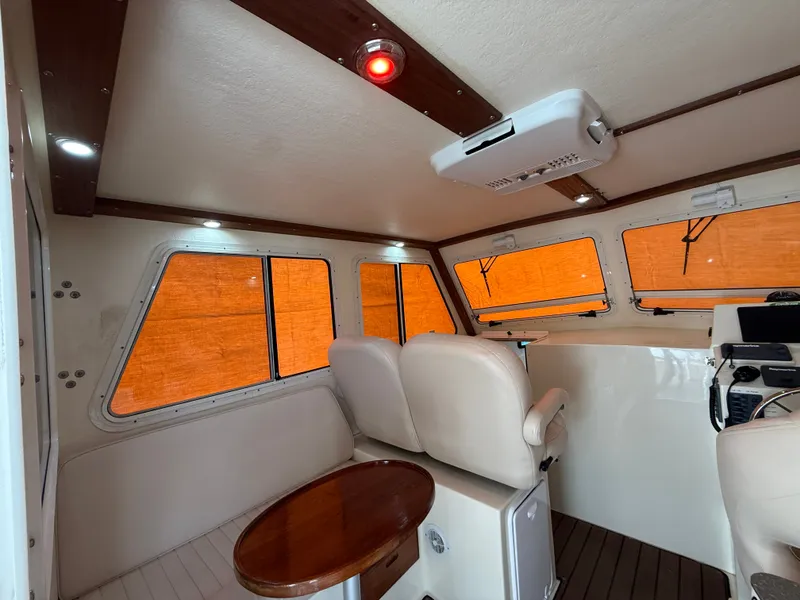 Slide: The Image of Interior of a 2018 Eastern 27 Islander Hardback boat with seating area. - 33