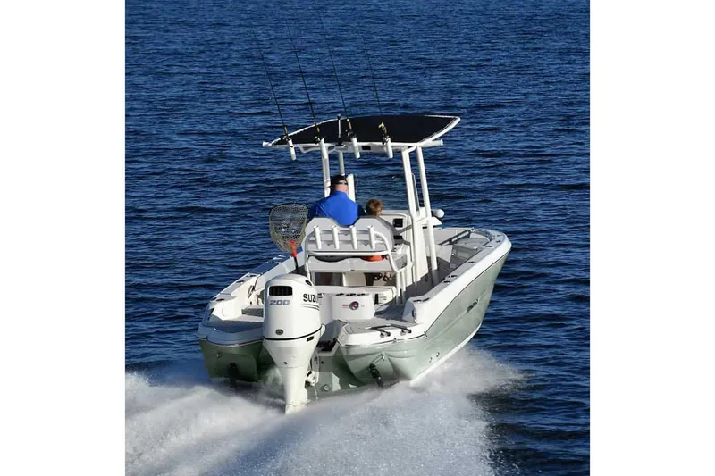 Slide: The Image of Manufacturer Provided Image: 2025 Stingray 216 CC boat cruising on open water, rear view. - 12