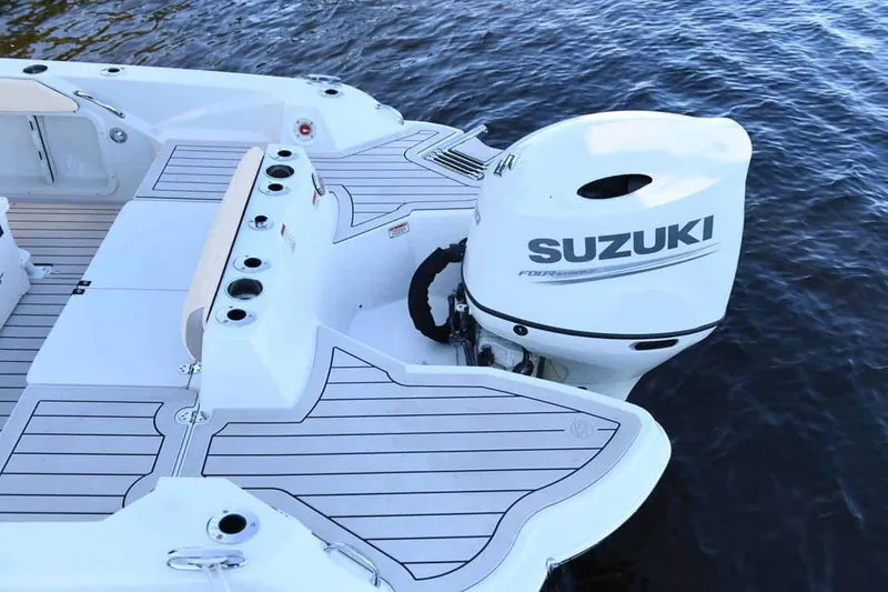 Slide: The Image of Manufacturer Provided Image: 2025 Stingray 216 CC boat with Suzuki outboard motor on water. - 14