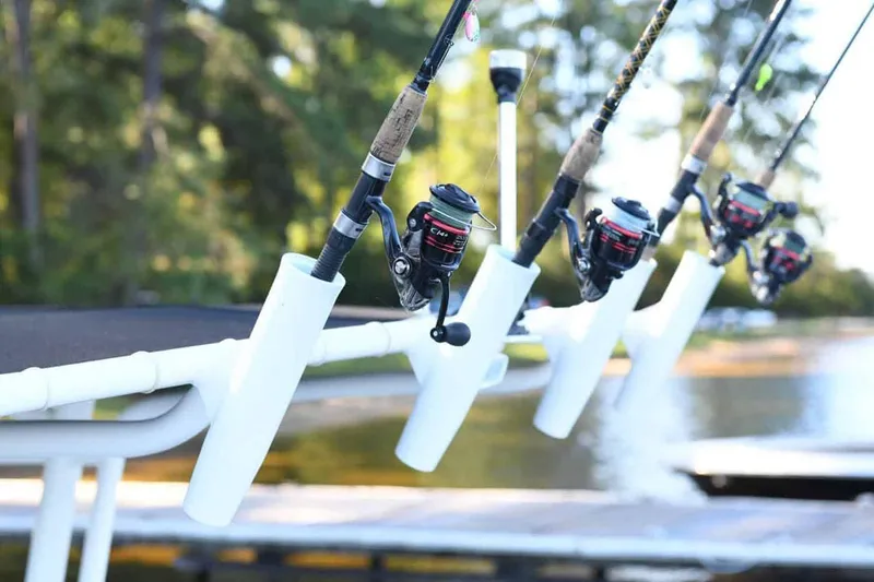 Slide: The Image of Manufacturer Provided Image: Fishing rods on a 2025 Stingray 216 CC boat by the water. - 16