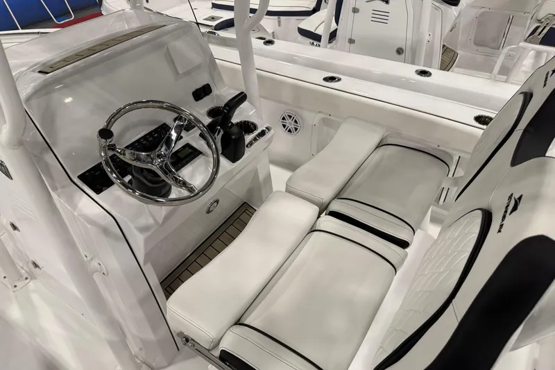 Slide: The Image of 2026 Stingray 216 CC boat interior with sleek steering console and cushioned seating. - 4