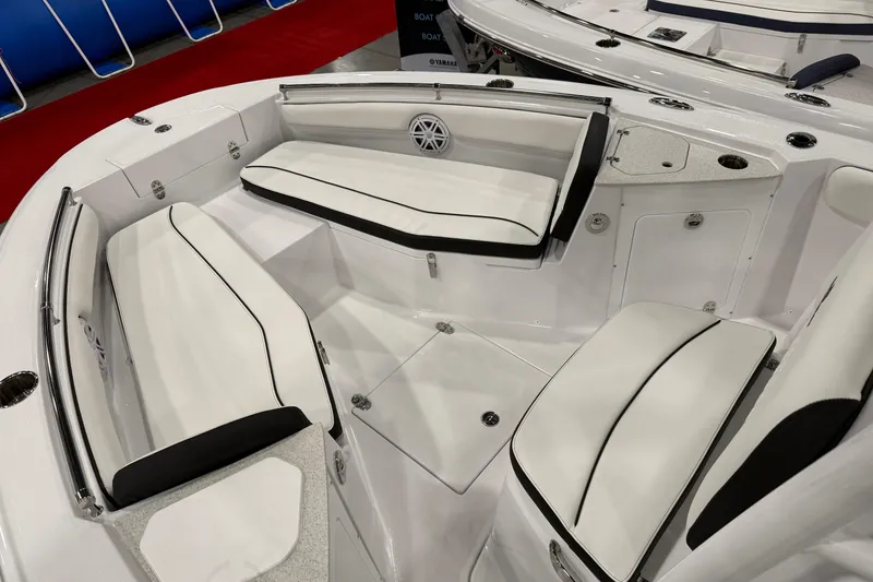 Slide: The Image of 2026 Stingray 216 CC boat interior with white cushioned seating and sleek design. - 6