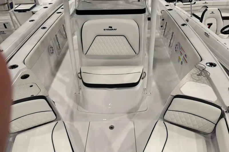 Slide: The Image of 2026 Stingray 216 CC boat interior with white seating and modern design. - 7