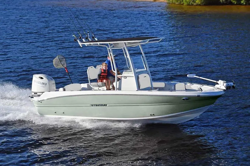 Slide: The Image of Manufacturer Provided Image: 2025 Stingray 216 CC boat cruising on a lake with fishing gear. - 9