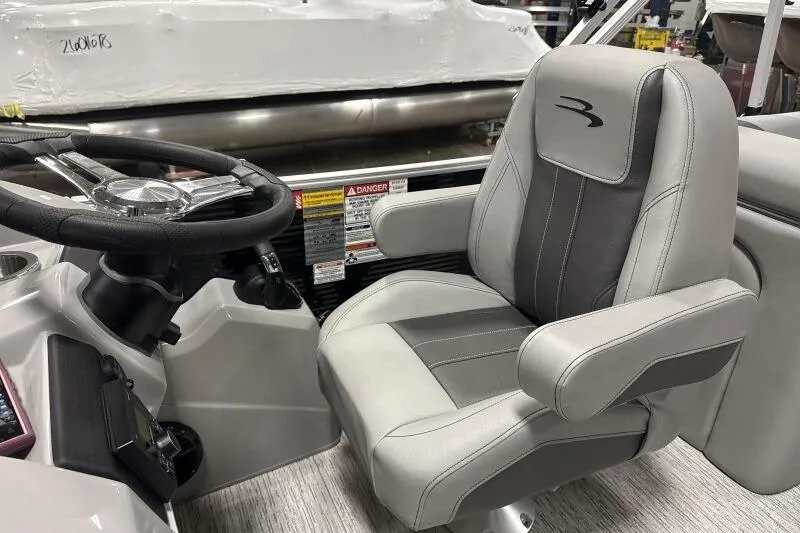 Slide: The Image of Captain's seat and steering wheel of 2026 Bennington 24SXSR pontoon boat. - 7