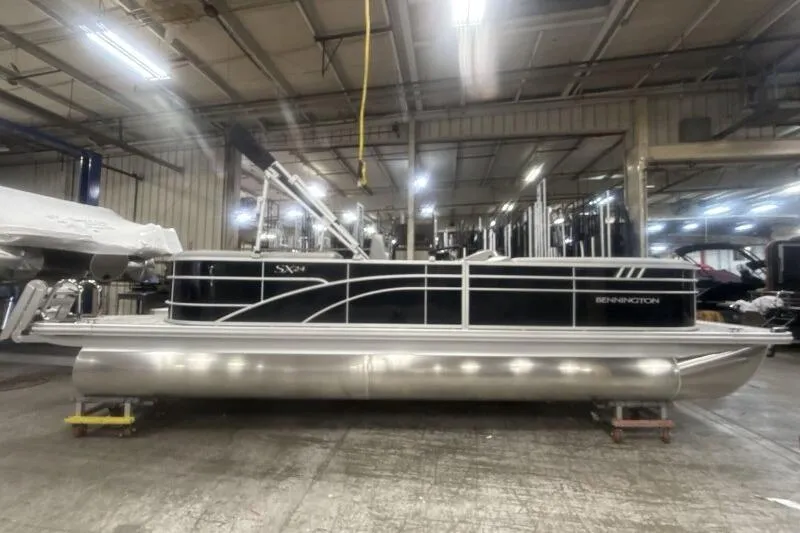 Slide: The Image of 2026 Bennington 24SXSR pontoon boat in a factory setting, showcasing sleek design. - 8