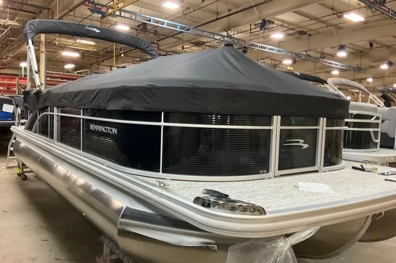 Slide: The Image of 2026 Bennington 24SXSR pontoon boat with cover in a factory setting. - 9