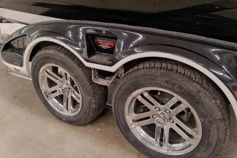 Slide: The Image of 2026 Ranger 620xFS Pro trailer with chrome wheels and Kendal tires in a garage. - 10