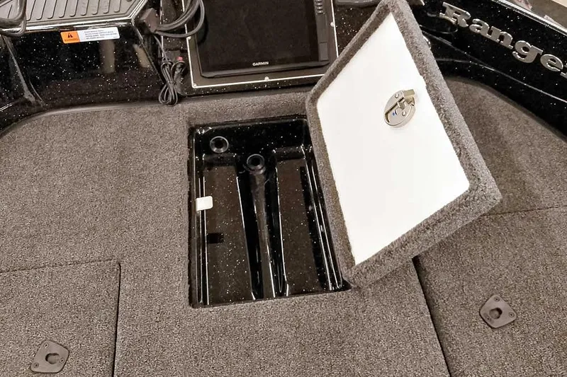 Slide: The Image of 2026 Ranger 620xFS Pro boat interior with open storage compartment and electronic display. - 18