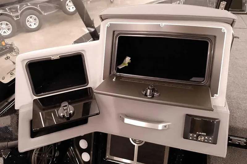 Slide: The Image of 2026 Ranger 620xFS Pro boat dashboard with storage compartments and JL Audio system. - 25