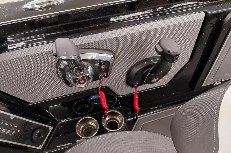 Slide: The Image of Control panel of 2026 Ranger 620xFS Pro boat with throttle and cup holders. - 27