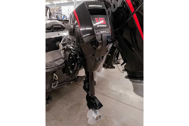 Slide: The Image of 2026 Ranger 620xFS Pro with Mercury 15 Pro outboard motor in a garage setting. - 3