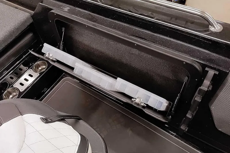 Slide: The Image of 2026 Ranger 620xFS Pro boat interior storage compartment with cup holders and seating. - 35