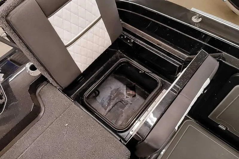 Slide: The Image of 2026 Ranger 620xFS Pro boat interior with open storage compartment and cushioned seating. - 39