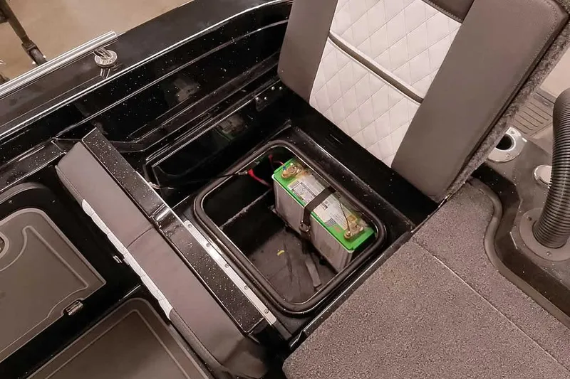 Slide: The Image of 2026 Ranger 620xFS Pro boat battery compartment with seating and storage. - 40