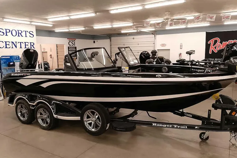 Slide: The Image of 2026 Ranger 620xFS Pro boat displayed in a showroom, featuring sleek design and triple-axle trailer. - 47