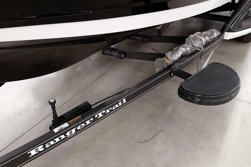 Slide: The Image of 2026 Ranger 620xFS Pro boat trailer with "Ranger Trail" branding, parked indoors. - 6